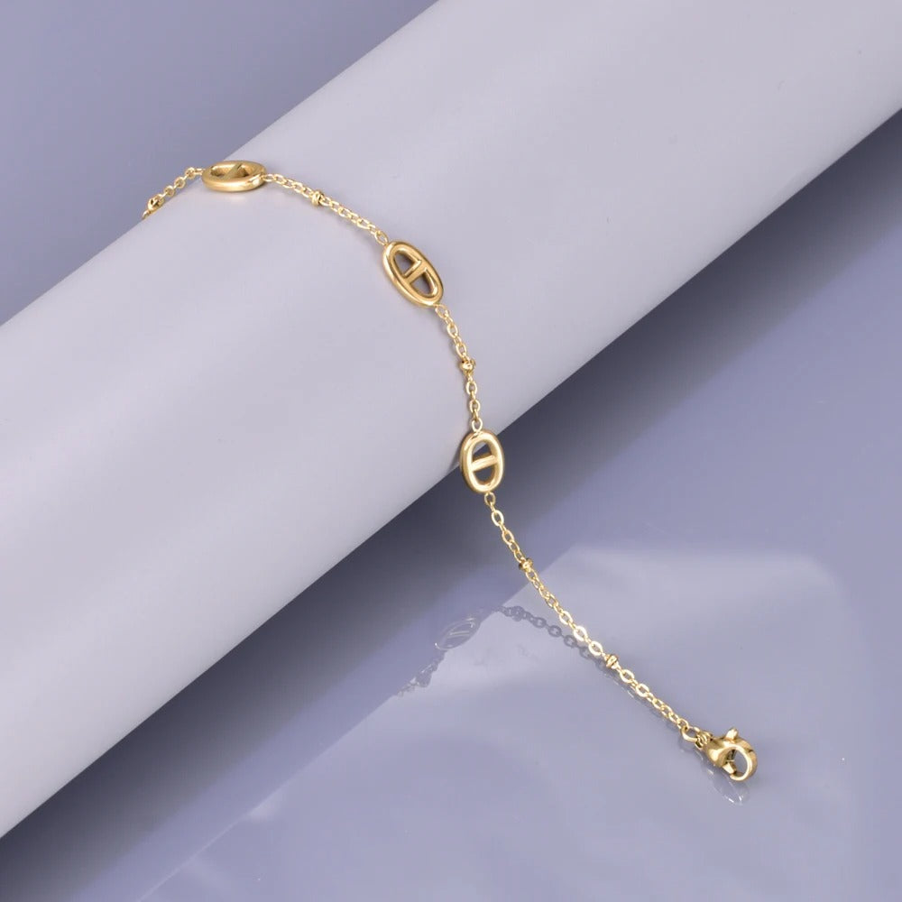 Gold-Plated Stainless Steel Bracelet – Oval Charm Link Chain with Adjustable Clasp & Muted Gray Backdrop